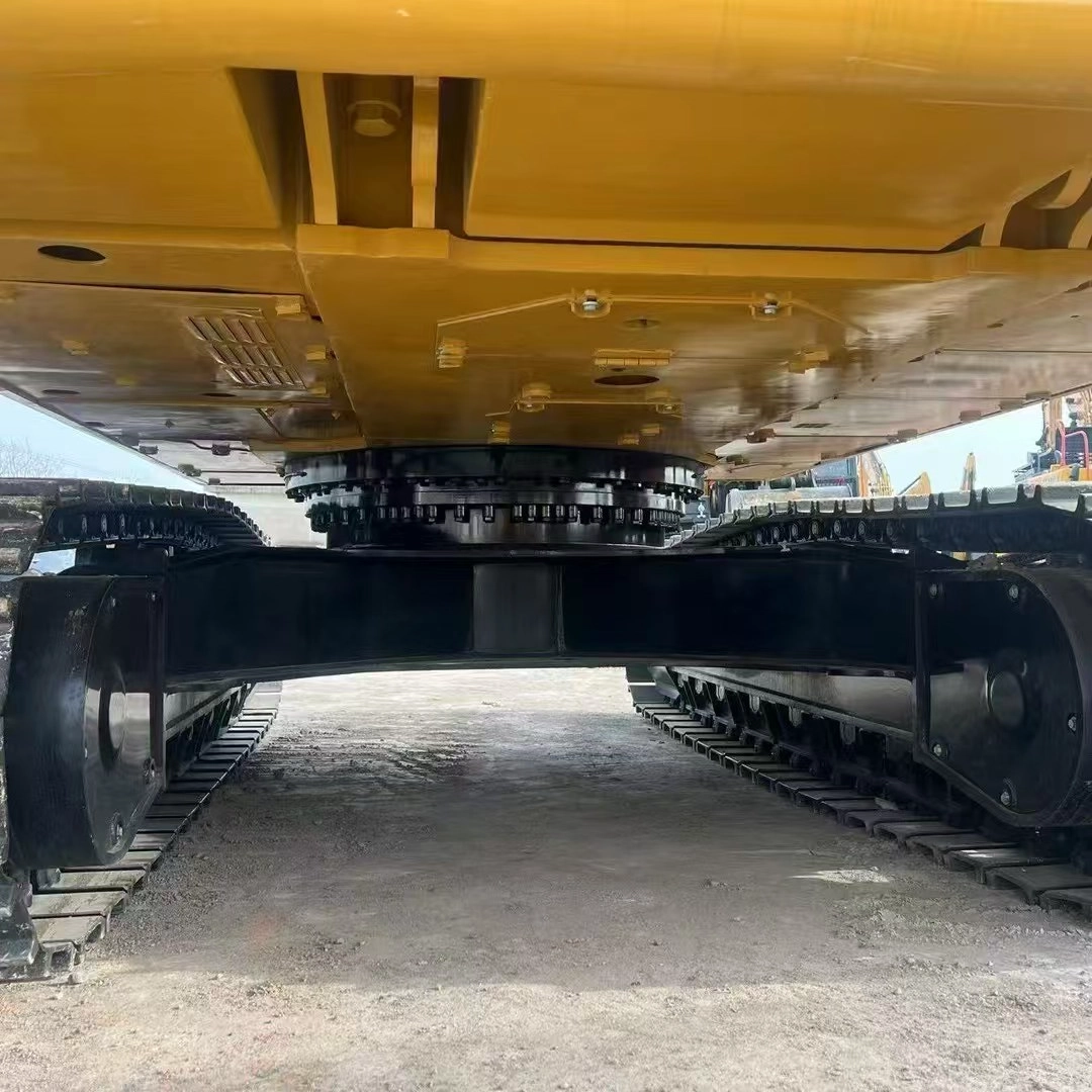 Bottom view of excavator undercarriage, swing bearing, and track frame with glossy paint. Bottom view of excavator undercarriage, swing bearing, and track frame with glossy paint.