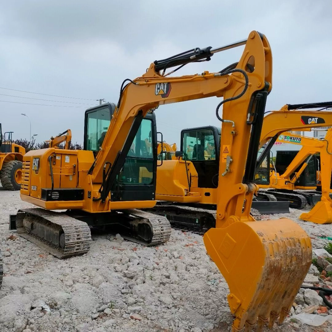 Used Caterpillar 305.5E2 excavator full body parked on gravel with moderate bucket wear.
