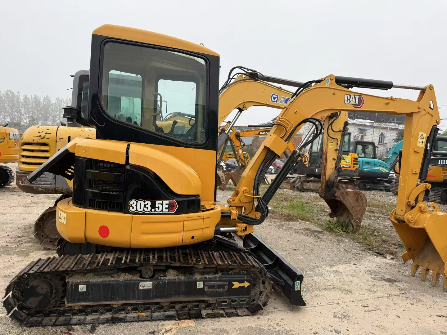 Used Caterpillar CAT 303.5E mini excavator full body showing minor wear in machinery yard Used Caterpillar CAT 303.5E mini excavator full body showing minor wear in machinery yard.